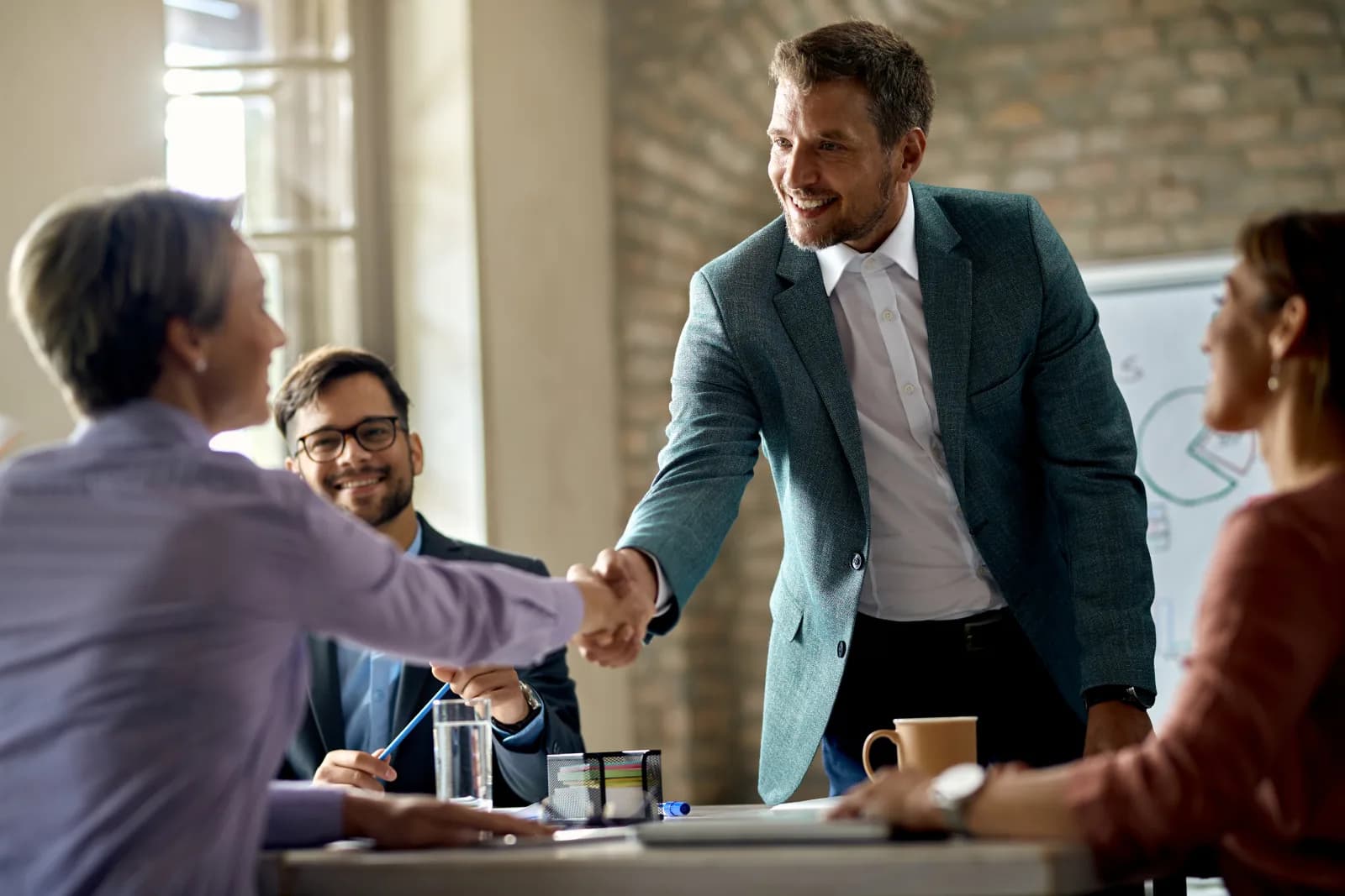 Business partners shaking hands at a Bitcoin Poland meeting