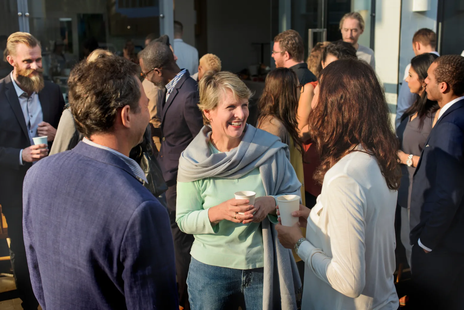 Conference guests in conversation over coffee